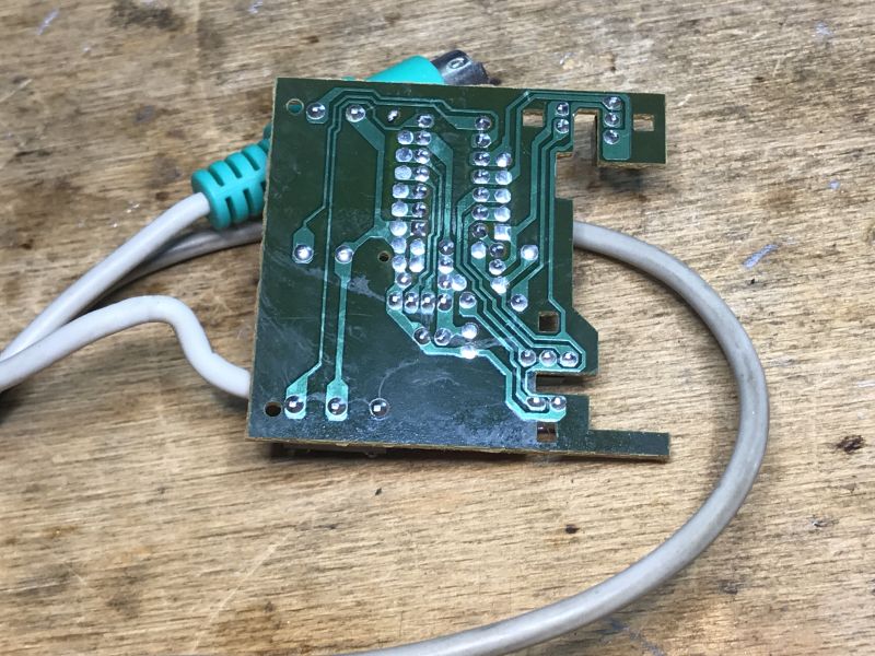 Computer Mouse Printed Circuit Board with PS/2 Cable Printed circuit board from a computer mouse with a PS/2 connector cable.