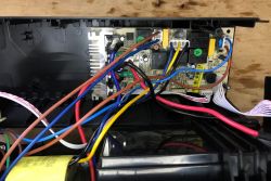 Inside a UPS: PCB with wiring and a battery in a black housing