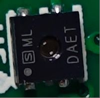 Close-up of ML DAET Electronic Component Close-up of a black electronic component marked ML DAET.