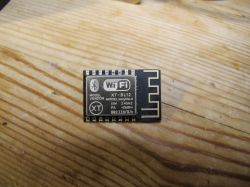 Cozylife XT-BL12 Wi-Fi Module Cozylife XT-BL12 Wi-Fi module on a wooden background.