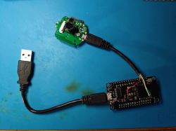 NodeMCU board connected to a camera PCB using a modified USB cable with exposed wires.
