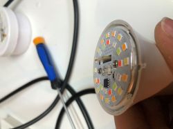 LED Bulb with Colored LEDs and Integrated Circuit Close-up image of an LED bulb with visible colored LEDs and an integrated circuit.