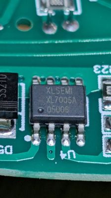 Close-up of XL7005A chip on green PCB with visible solder joints and traces