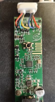 Electronic board with several colored wires connected at the top.