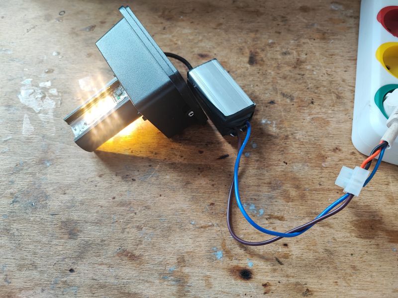 LED Lamp Testing with SM15155 Controller Lamp with connected wires on a workshop table.