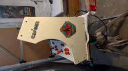 Bartop Arcade Cabinet with Capcom Stickers Bartop arcade cabinet with Capcom logo, stickers, and red buttons.