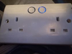 Double electrical socket with two round illuminated buttons on top