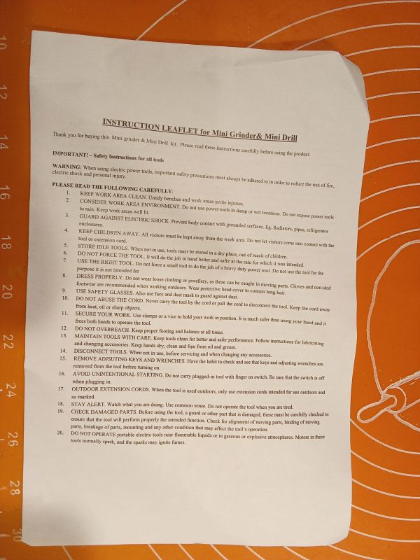 Instrukcja obsługi mini szlifierki i mini wiertarki na pomarańczowym tle.