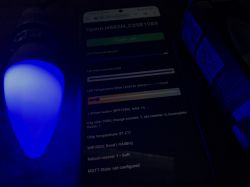 Controlling Tuya LED bulb with custom OpenBK7231T firmware Smartphone screen showing LED bulb control interface with custom firmware, next to a glowing blue LED lamp.