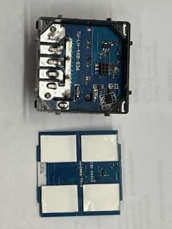 Interior of an electronic device with a circuit board and four buttons.