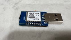 Tuya WBR3 WiFi Module with USB Plug – Top View Tuya WBR3 WiFi module on PCB with USB connector, top view, on a light surface.
