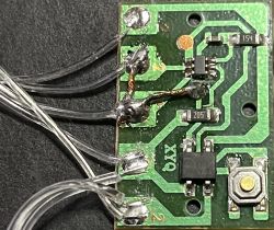 Close-up of a modified EK-04 circuit board with soldered wires.