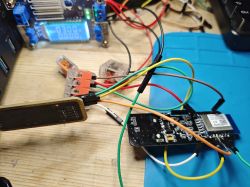 Electronic Circuit Board with Wires Electronic circuit board with colorful wires on a wooden table.