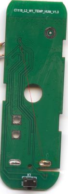 Green PCB with a central hole, traces, and the text “C1118_L2_W1_TEMP_HUM_V1.3”