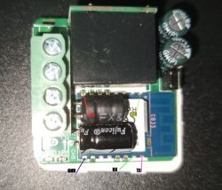 A circuit board with visible pins labeled as GND, RX, TX, CEN, and capacitors.