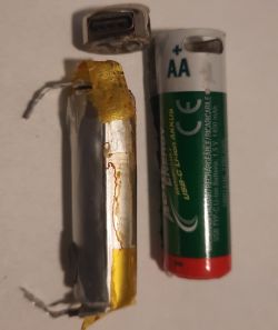 Dismantled AA Battery with Lithium-Ion Cell View of the inside of an AA battery with a damaged lithium-ion cell.
