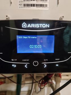 Close-up of Ariston boiler control panel showing firmware version 02.10.03