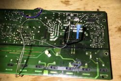 Circuit board with soldered wires and a transistor.