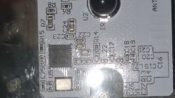 Close-up of a PCB with SMD parts and markings (R, C, U) and a black integrated circuit