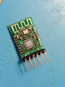 HC-05 Bluetooth module with IC and pin header on blue background
