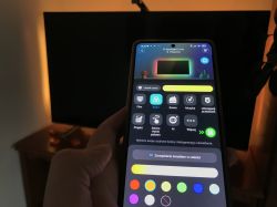 Smartphone with Govee app in front of a TV with backlight LED turned on