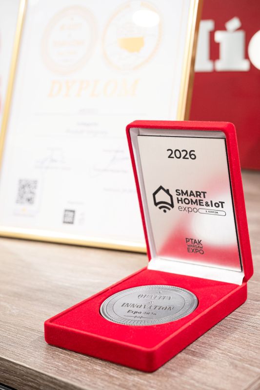 Open red case with a Smart Home &amp; IoT Expo 2026 medal; a blurred diploma in the background