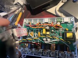 Image showing a disassembled electronic device with a visible circuit board and wires.