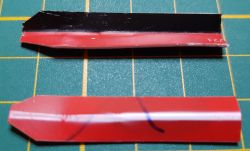 Two wedges made from credit cards on a green cutting mat.