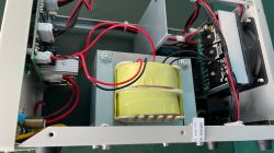 Interior of a Korad power supply with a visible transformer and wiring.