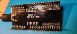 A black ESP downloader board on a blue background with Chinese writing and the date 2021 8 10.