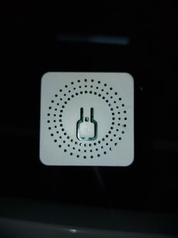 Front of Tuya Mini Smart Switch Casing Top view of the Tuya Mini Smart Switch casing in a square shape with ventilation holes.