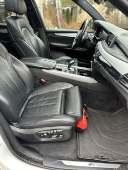 Car interior with black leather seats and a center console.