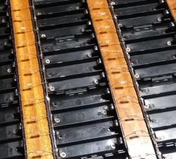 18650 cell holders on wooden base with copper wire interconnections.