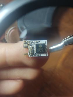 Close-up of a small electronic module held in hands.