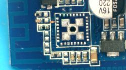 Close-up of a blue printed circuit board with SMD components and an empty socket for an integrated circuit.