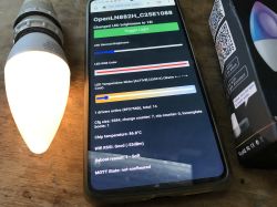 WiFi LED Bulb Configuration Using Custom OpenBK7231T Firmware WiFi-controlled LED bulb with custom firmware and smartphone displaying configuration interface.