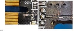 Zbliżenie na uszkodzoną płytkę PCB przy złączu PCI.