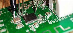 Close-up of a circuit board with LN8825B chip and connected wires.