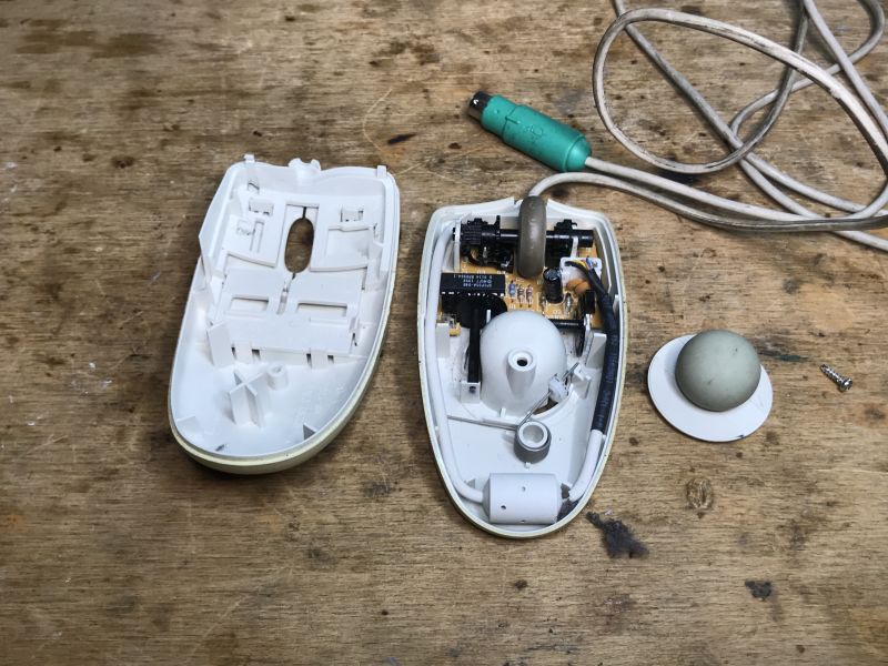 Interior of a Trekker Ball Computer Mouse Interior of an opened Trekker ball computer mouse on a wooden table.