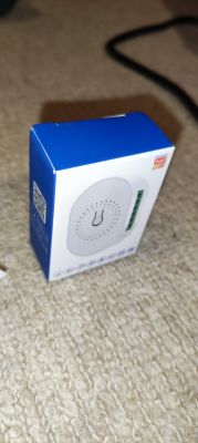 Tuya product box on a beige carpet.