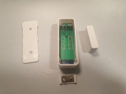 Disassembled DS06 door sensor with visible interior.