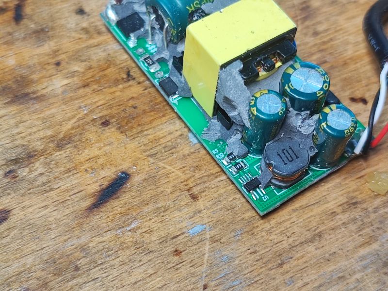 Power Supply Module on a Wooden Surface Close-up of a power supply module on a wooden surface