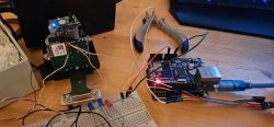 Electronic setup with Arduino connected via UART on a wooden table.