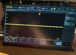Portable ARZOPA monitor showing a RIGOL oscilloscope interface with a yellow waveform trace on the screen