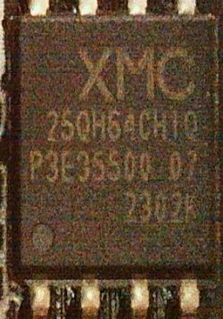 Close-up of a chip labeled XMC on a PCB.