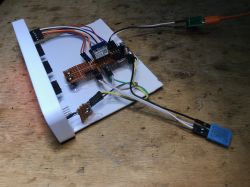 DIY Prototype Device with WiFi and Sensors DIY prototype device with electronic components on a white base.