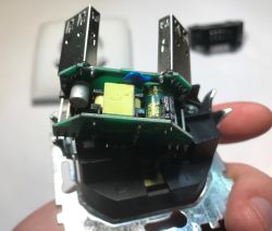 Inside a USB wall outlet: two PCB boards and a yellow transformer in a black housing