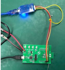 Circuit board with connected cables and a blue USB module.