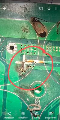 Damaged circuit board with a broken conductor.