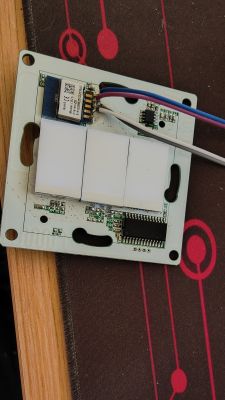 Electronic Module with Buttons and Wiring Electronic module with three white buttons and wiring on a circuit board.